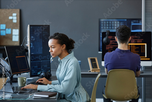Young computer programmers coding on computer in office