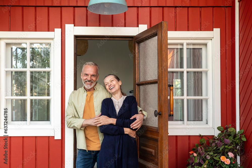 Happy couple spending leisure time near doorway Happy couple spending leisure time near doorway