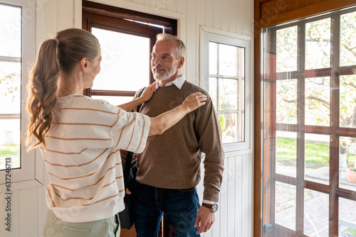 Woman saying goodbye to man leaving for work photo