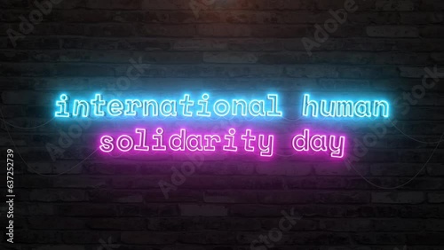 International human solidarity day with neon text effect in wall background. Seamless looping video