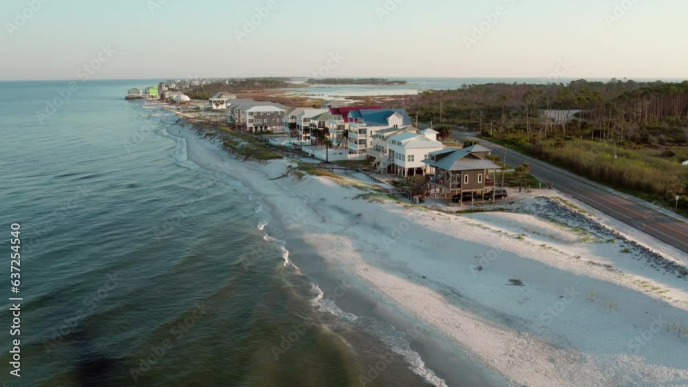 Aerial shot of luxurious beach front homes raised up on stilts on the Gulf of Mexico Aerial shot of luxurious beach front homes raised up on stilts on the Gulf of Mexico