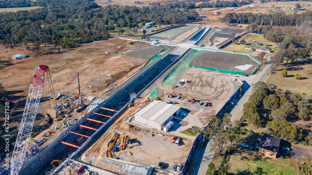 Fototapeta premium Aerial drone view of the construction site of the new metro station at Orchard Hills in Western Sydney, NSW Australia on a sunny day in August 2023 