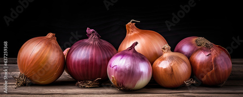Onions on wooden board. Fresh onion against old wood table.  copy space for text photo