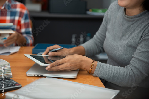 Business Plan Concept.Two Business people meeting and planning financial data to start up project strategy for new target.Professional Accountant holding tablet and point report on office desk.