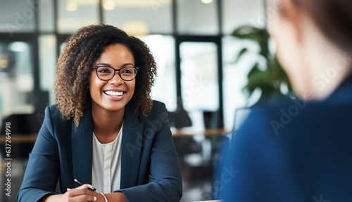 Female hiring manager interviewing a job candidate in her office photo