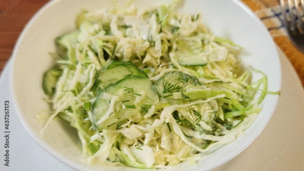 Portion of green salad of sliced fresh vegetables in bowl Portion of green salad of sliced fresh vegetables in bowl