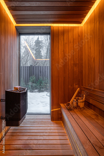 Finnish sauna interior with broom and bucket