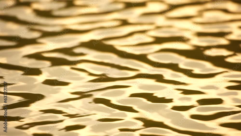 Sun reflecting on sparkling sea lake water surface, ocean at sunset, sunrise. Sunrays flickering in Ripples on water surface. Golden shimmering sea waves in sun. Slow motion. Abstract nautical nature Sun reflecting on sparkling sea lake water surface, ocean at sunset, sunrise. Sunrays flickering in Ripples on water surface. Golden shimmering sea waves in sun. Slow motion. Abstract nautical nature