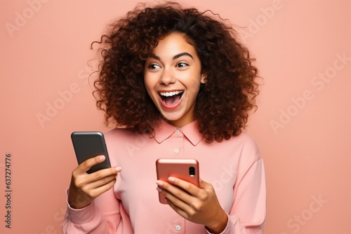 Young happy lucky woman student feeling excited winner looking at cellphone using mobile phone winning online, receiving great news or sms offer, getting new job celebrating achievement