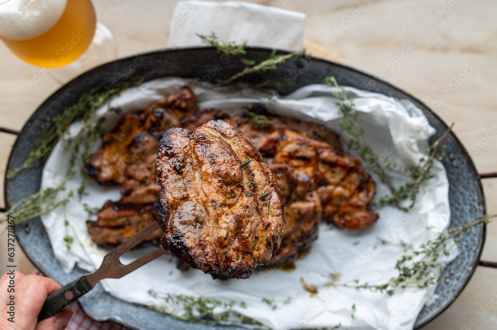 Grilled pork steak on a meat fork