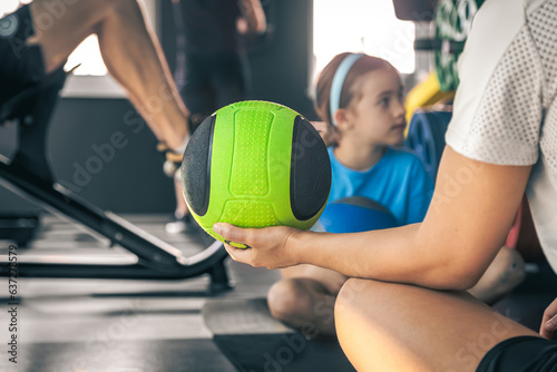 Close-up, ball in woman's hand, concept of training with a child. © puhimec