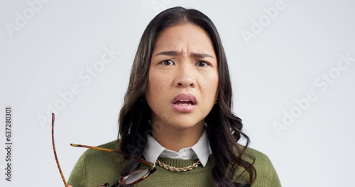 Confused, face and woman in studio with glasses for choice, decision or ask on grey background space. Portrait, wtf and asian female model with questions, doubt and why emoji for omg, thinking or huh