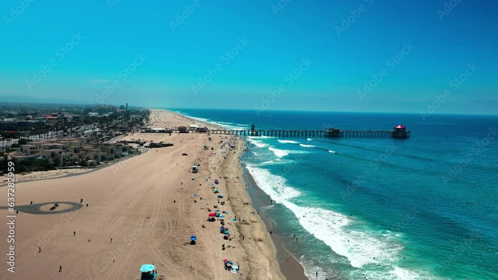 Flying over the Pacific Ocean beach and towards the Pier in Huntington Beach California. Flying over the Pacific Ocean beach and towards the Pier in Huntington Beach California.
