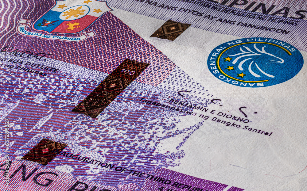 Fototapeta premium Extreme macro photography of a 100 Peso banknote. Ultra close up of a one hundred filipino peso note. Legal Tender for private and public of the island state of the Philippines. Microscopic capture