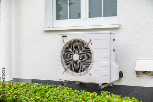 Air source heat pumps installed outside of city house photo