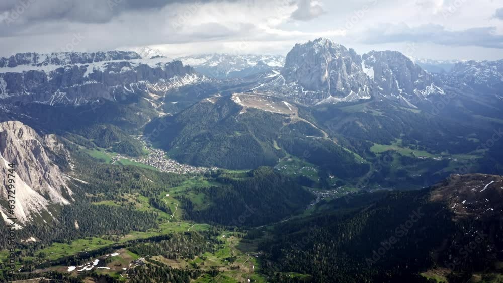 Rocky Italian Dolomites Mountains during a beautiful sunrise and sky. Sassolungo, Langkofel. Drone aerial with some snow and it's calm and there's a forest. Rocky Italian Dolomites Mountains during a beautiful sunrise and sky. Sassolungo, Langkofel. Drone aerial with some snow and it's calm and there's a forest.