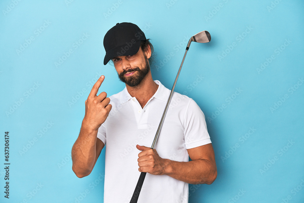 Long-haired golfer with club and hat pointing with finger at you as if inviting come closer.