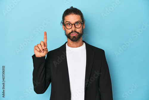 Businessman in suit with eyeglasses and beard having some great idea, concept of creativity.