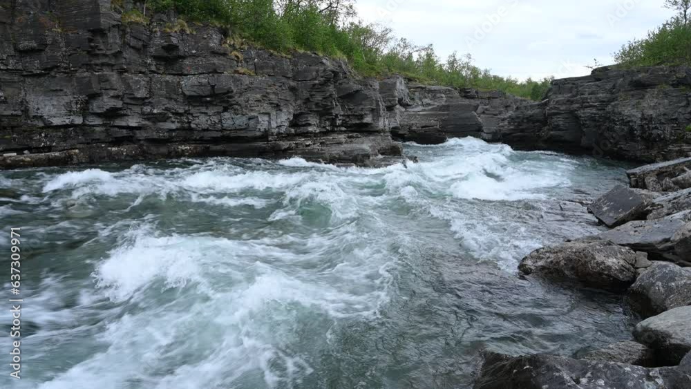 Mountain river stream in Northern Sweden. Beautiful Summer day at the river on mountains. Mountain river stream in Northern Sweden. Beautiful Summer day at the river on mountains.