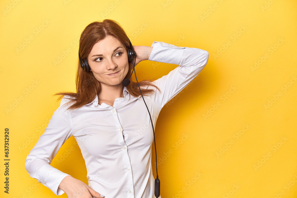 Call center redhead in white shirt, headphones on touching back of head, thinking and making a choice. Call center redhead in white shirt, headphones on touching back of head, thinking and making a choice.