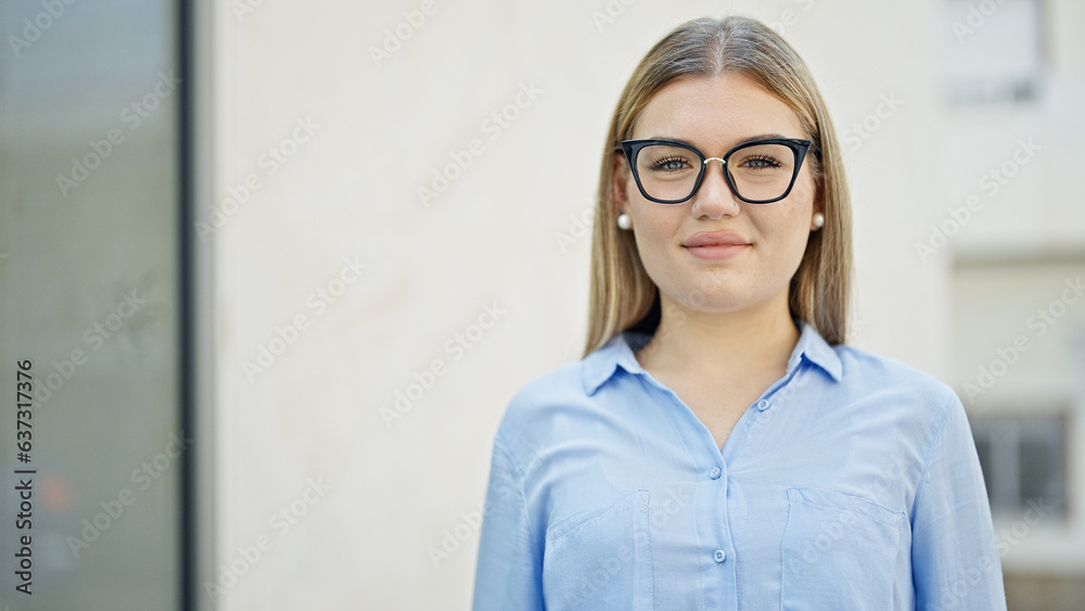 Young blonde woman business worker smiling confident standing at street Young blonde woman business worker smiling confident standing at street