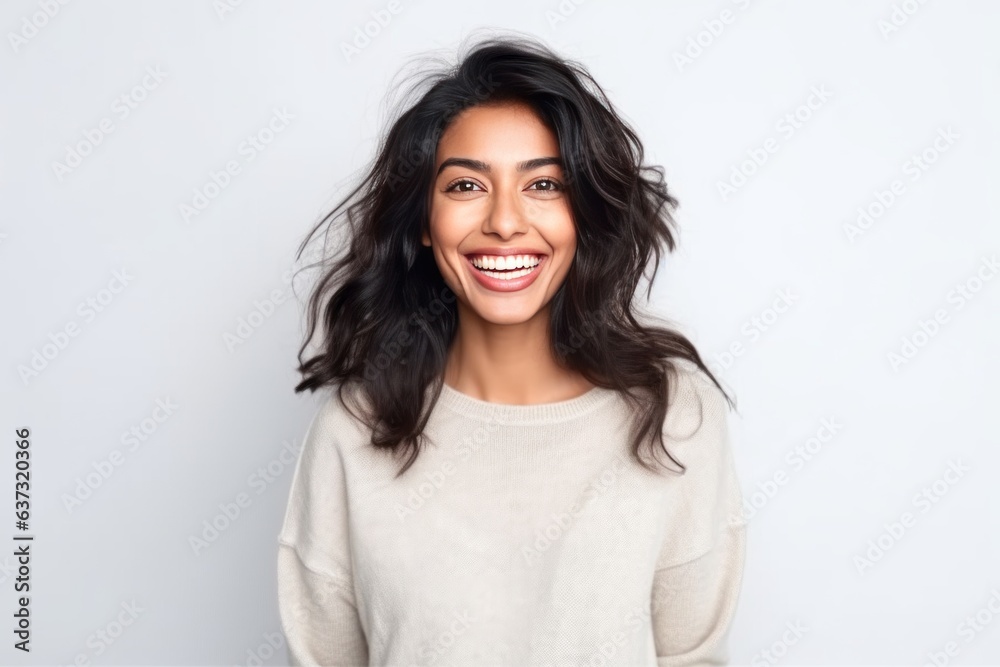 Medium shot portrait of an Indian woman in her 30s against a white background Medium shot portrait of an Indian woman in her 30s against a white background