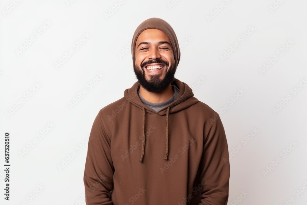 Medium shot portrait of an Indian man in his 30s wearing hijab against a white background Medium shot portrait of an Indian man in his 30s wearing hijab against a white background