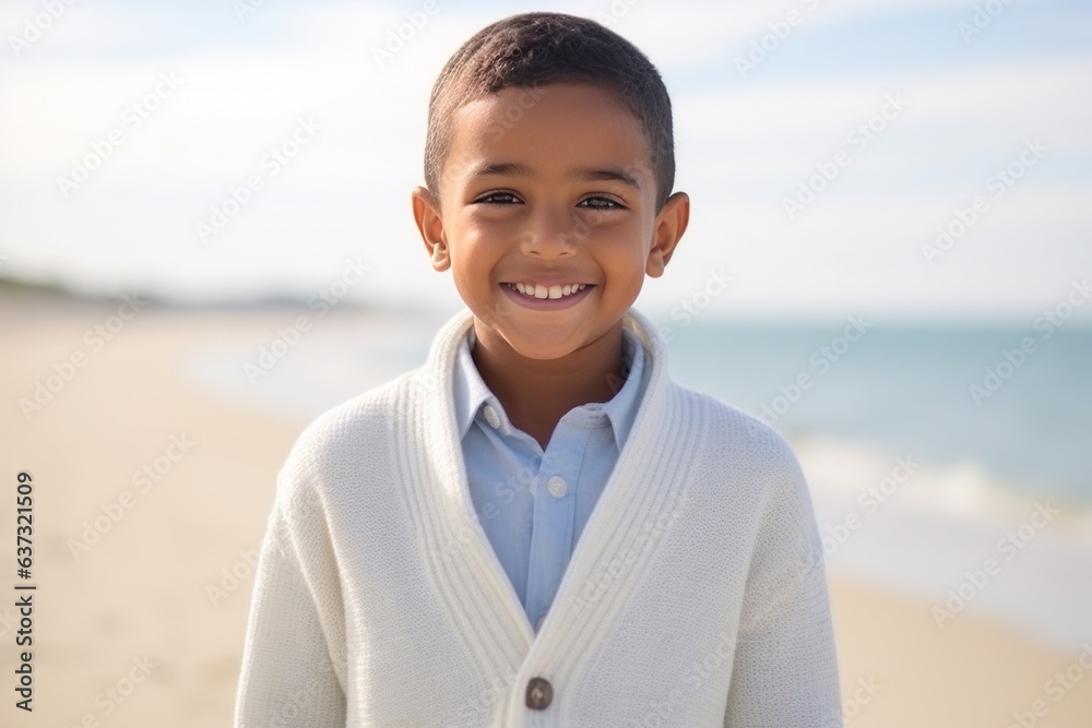 Medium shot portrait of an Indian child male in a beach Medium shot portrait of an Indian child male in a beach