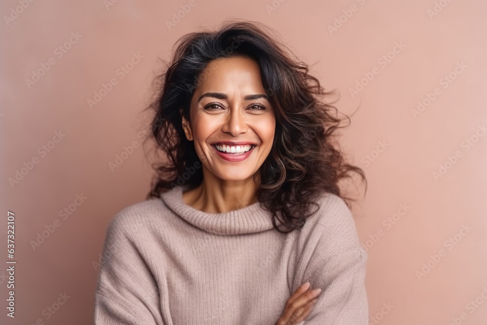 Medium shot portrait of an Indian woman in her 40s in a colorful background Medium shot portrait of an Indian woman in her 40s in a colorful background