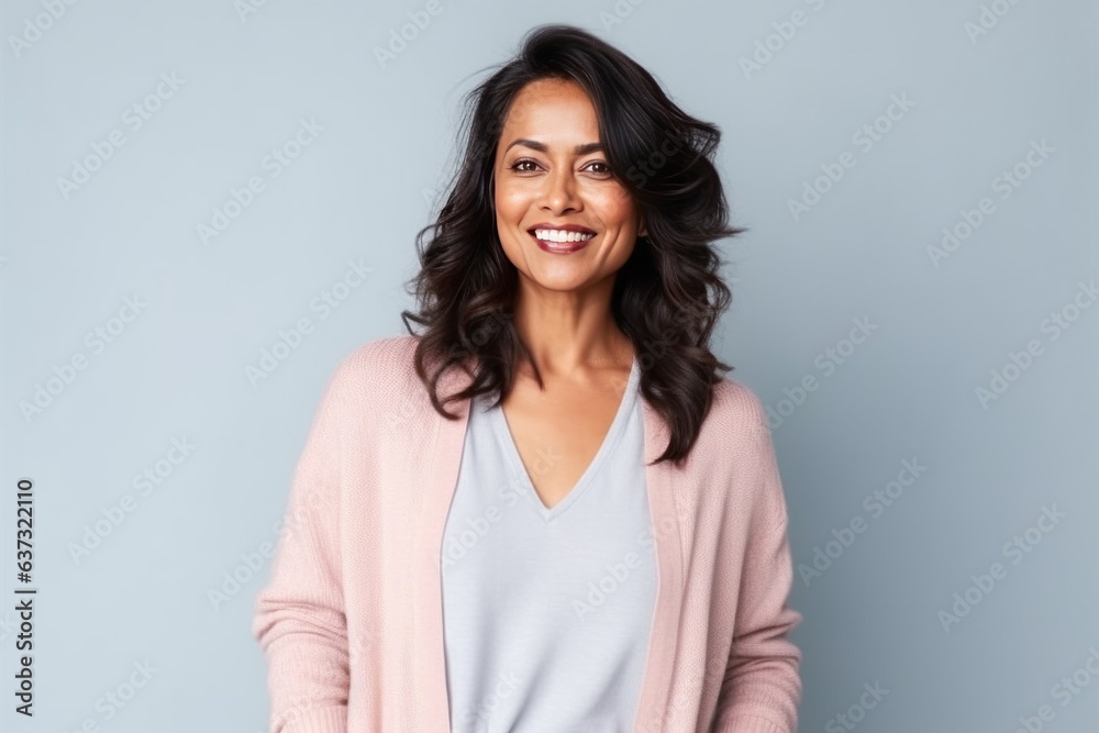 Medium shot portrait of an Indian woman in her 40s in a colorful background