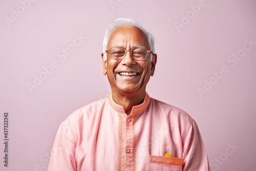 Medium shot portrait of an Indian man in his 80s in a colorful background