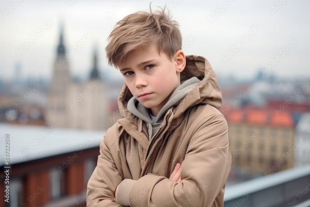 Sadness Boy In A Beige Coat On City Background. Сoncept Feeling Isolation In An Urban Environment, Sadness In Young Boys, The Impact Of Clothing And Colours On Moods, Mental Health In City Life