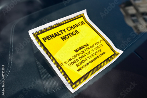 Penalty charge notice parking fine attached to windscreen photo