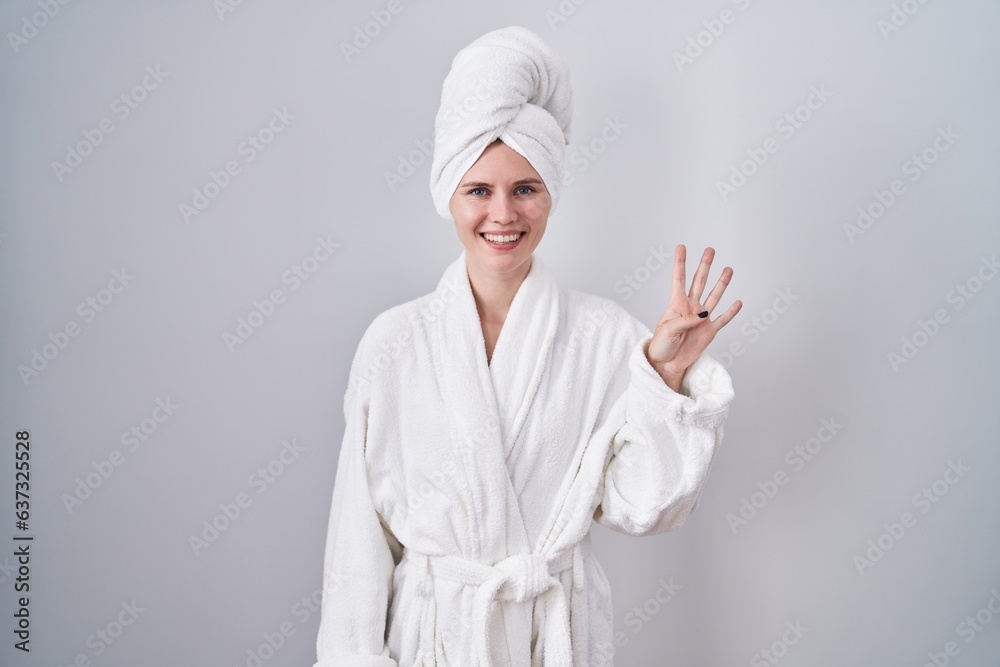 Blonde caucasian woman wearing bathrobe showing and pointing up with fingers number four while smiling confident and happy. Blonde caucasian woman wearing bathrobe showing and pointing up with fingers number four while smiling confident and happy.