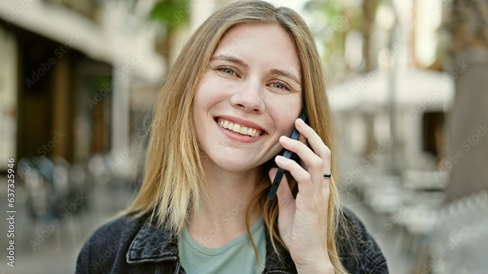 Young blonde woman smiling confident talking on the smartphone at street Young blonde woman smiling confident talking on the smartphone at street