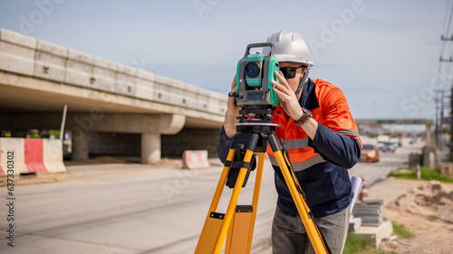 Engineer surveyors wearing uniform conversation notebook and blueprint check inspection by theodolite camera to measurement level position road construction site is industry transportation concept.