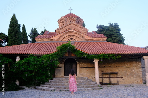 Church of Virgin Mary Peribleptos of Ohrid and a woman visiting photo