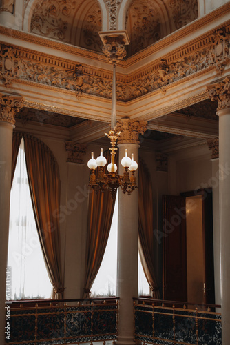Vintage brown gold interior with marble columns and royal chandelier. Aesthetics of historical architecture. Vertical © asauriet