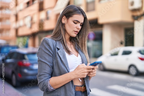 Young woman using smartphone at street © Krakenimages.com