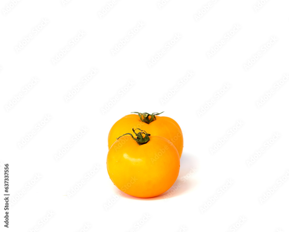 Two vibrant yellow tomatoes isolated on white background. Two vibrant yellow tomatoes isolated on white background.