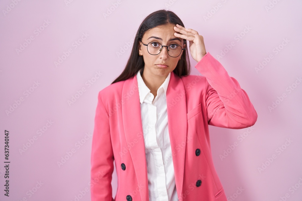 Young hispanic woman wearing business clothes and glasses worried and stressed about a problem with hand on forehead, nervous and anxious for crisis Young hispanic woman wearing business clothes and glasses worried and stressed about a problem with hand on forehead, nervous and anxious for crisis