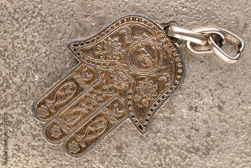 One metal keyring, Jewish "Hand of Miriam" on metal, close-up, top view.