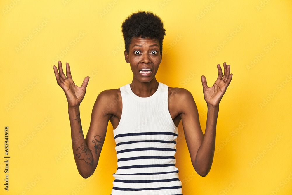 Vibrant African woman, white tank-top, yellow studio, screaming to the sky, looking up, frustrated. Vibrant African woman, white tank-top, yellow studio, screaming to the sky, looking up, frustrated.