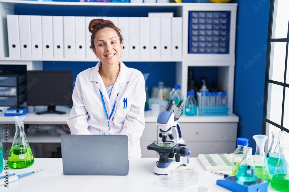 Young woman scientist using laptop working at laboratory Young woman scientist using laptop working at laboratory