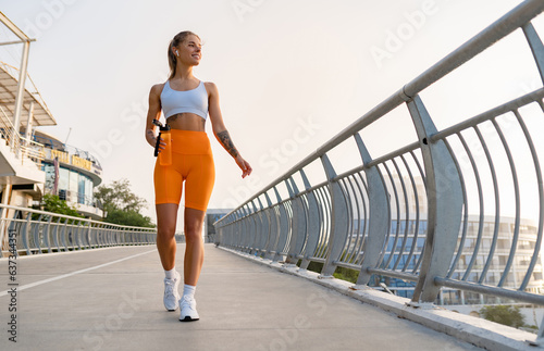 pretty young smiling woman doing sports in the morning in stylish sport outfit sportswear, skinny strong body, healthy fit lifestyle