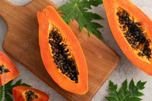 Cut Papaya over gray table background for tropical fruit design concept.