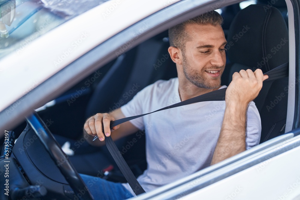 Young caucasian man smiling confident wearing car belt at street Young caucasian man smiling confident wearing car belt at street