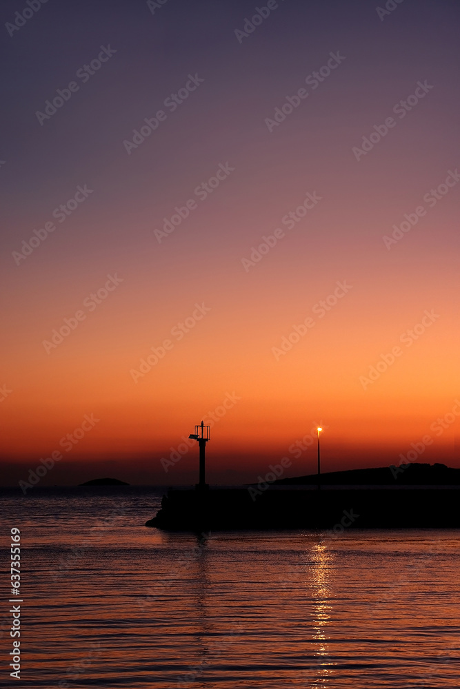 Silhouette of town Primosten, Croatia, illuminated by beautiful sunset light.