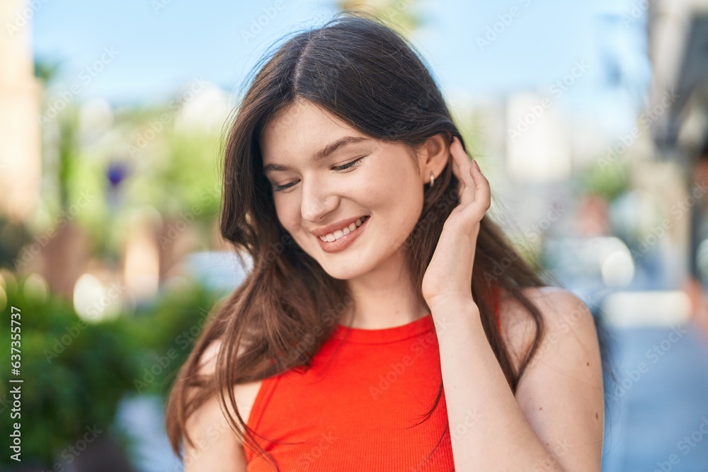 Young caucasian woman smiling confident looking to the side at street Young caucasian woman smiling confident looking to the side at street