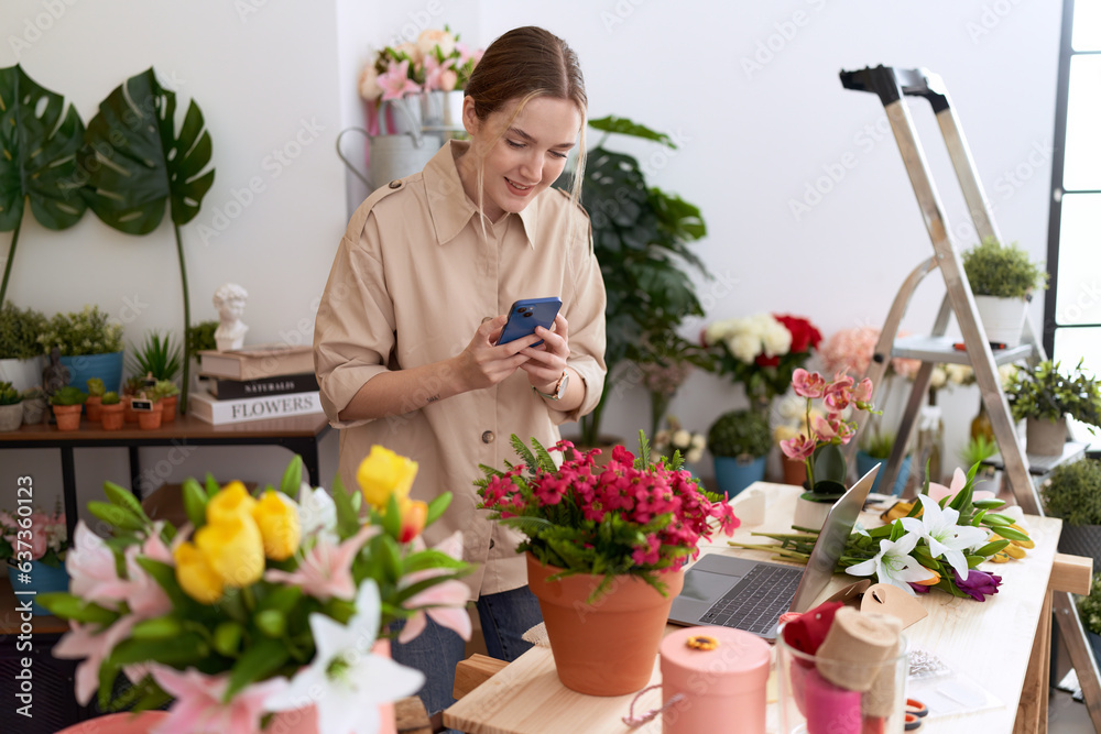 Young caucasian woman florist make photo to plant by smartphone at flower shop Young caucasian woman florist make photo to plant by smartphone at flower shop
